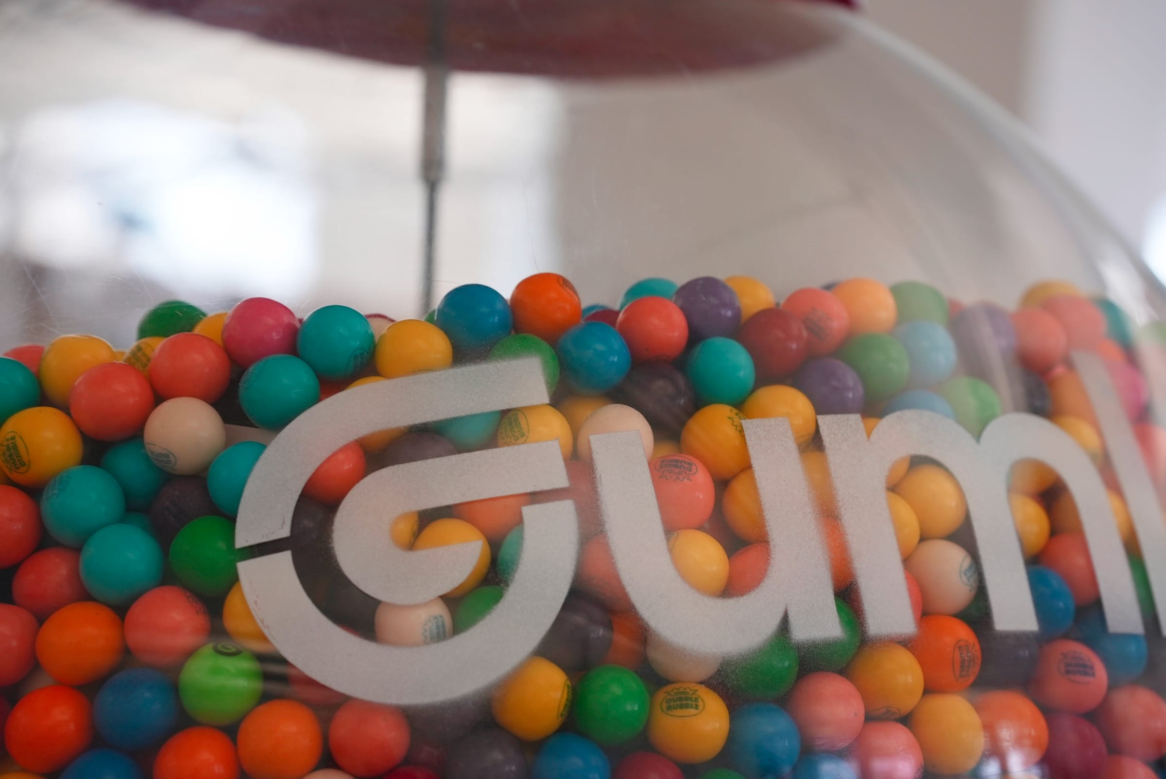 A close-up of the Cohorva-branded gumball machine in the office